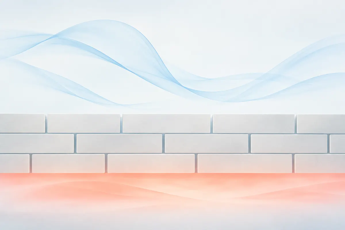 Stacked pale tiles forming a wall with small gaps, cool blue air above and soft coral warmth beneath
