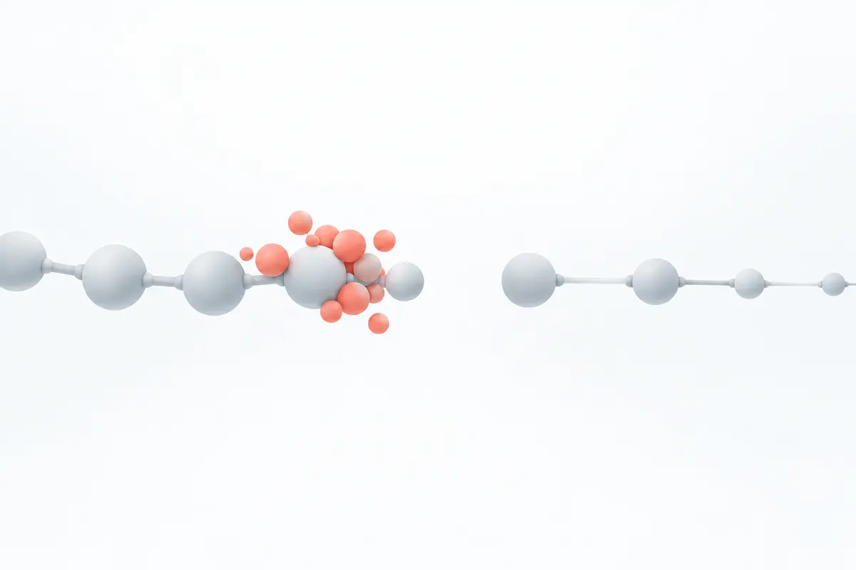A chain of linked pale spheres with one missing link, and coral spheres piling up just before the gap