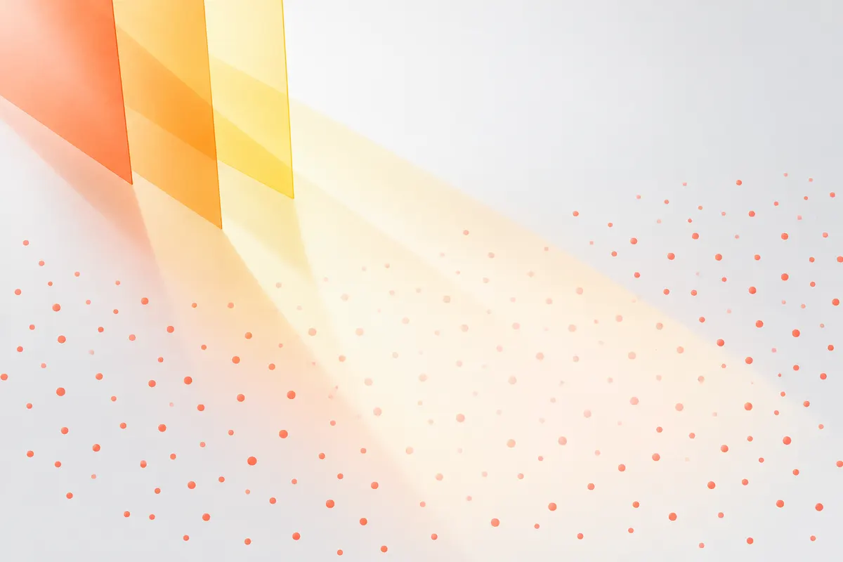 Light passing through overlapping orange, amber and pale yellow panes onto scattered coral dots, which look paler where the light falls