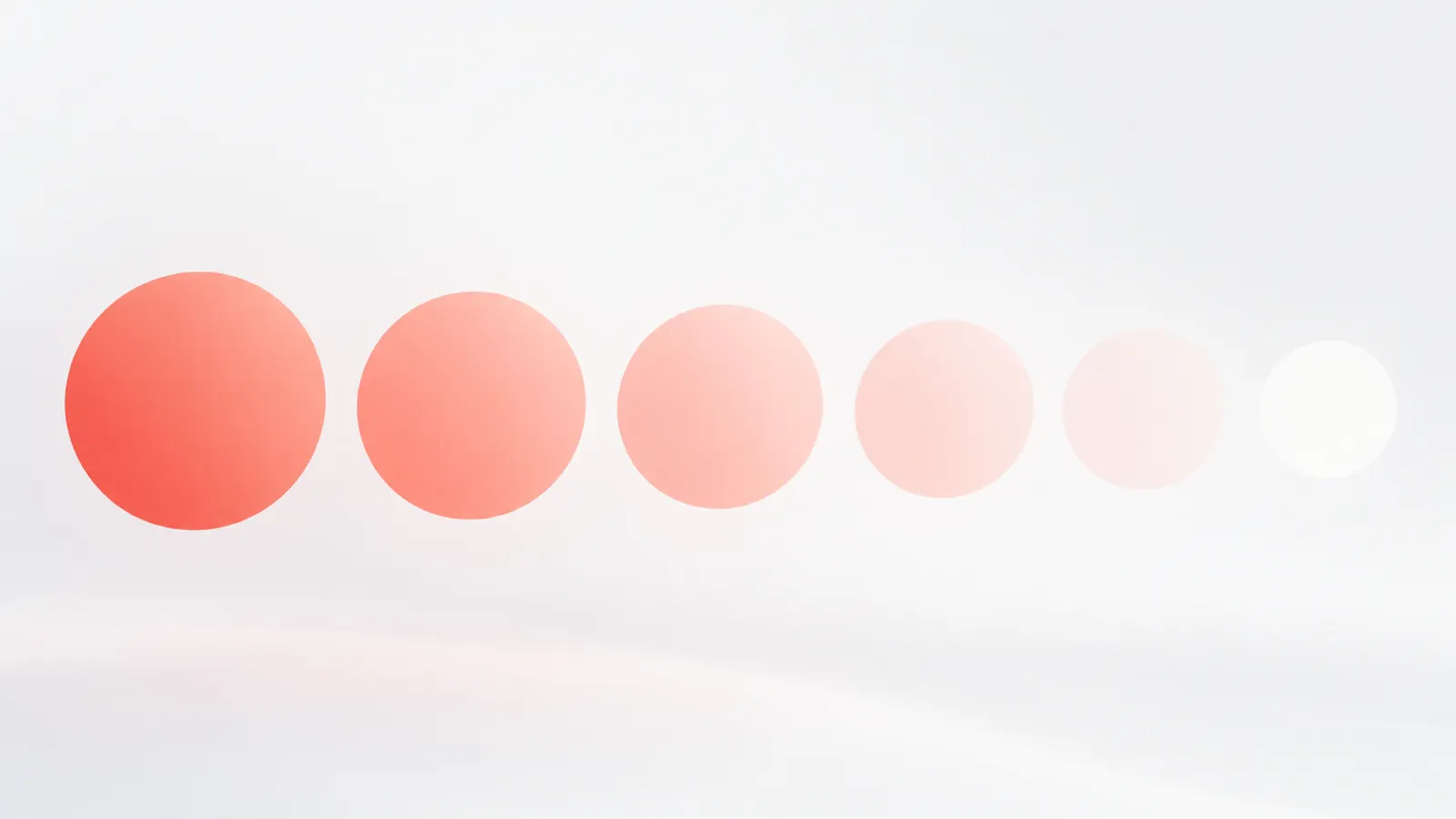 A row of circles cooling from deep coral on the left to pale blush and white on the right